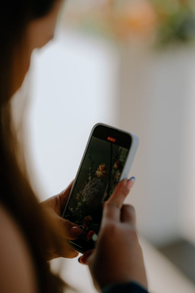 close up of phone of a wedding content creator getting a detail shot from a wedding
